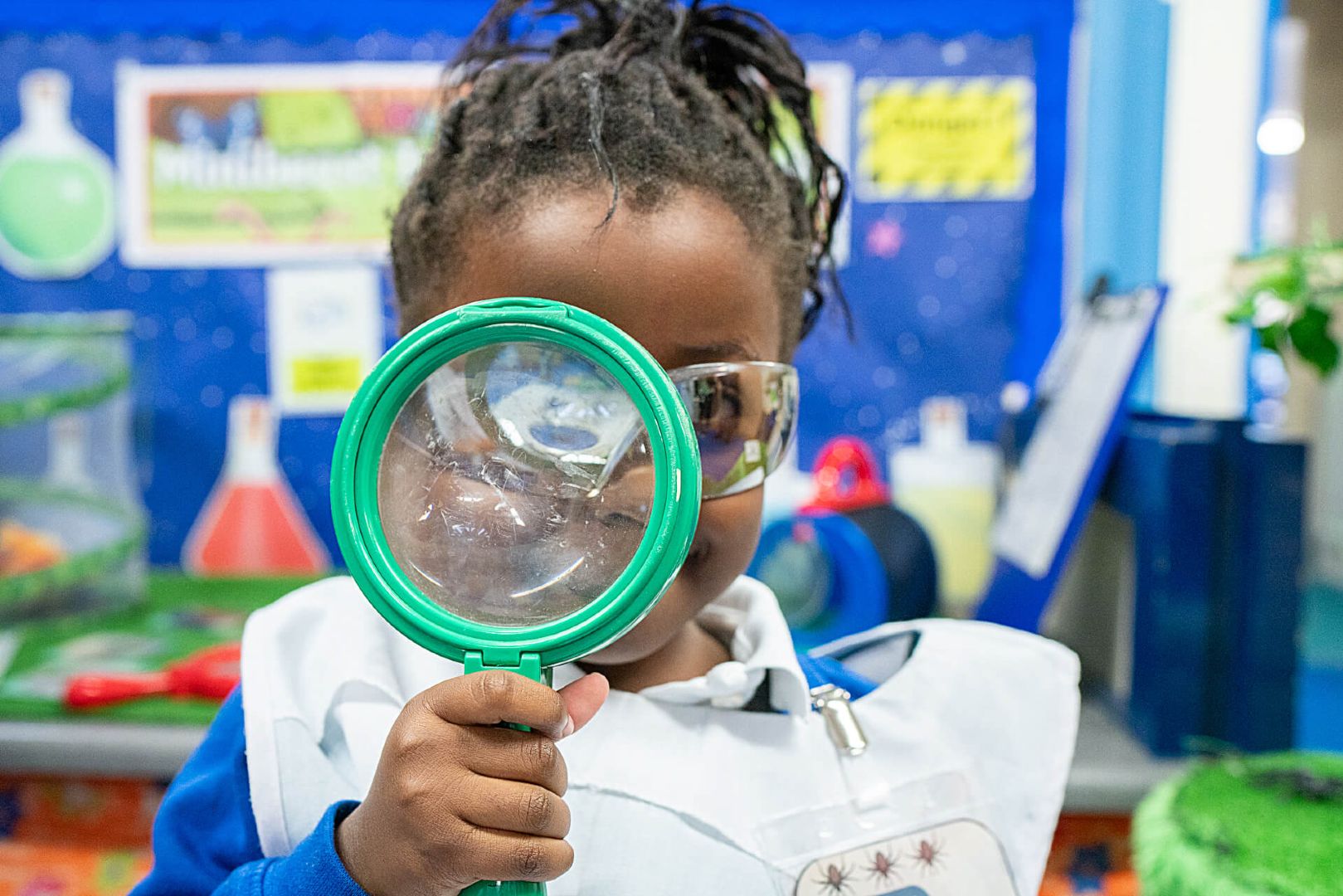 Child holding a magnifying glass